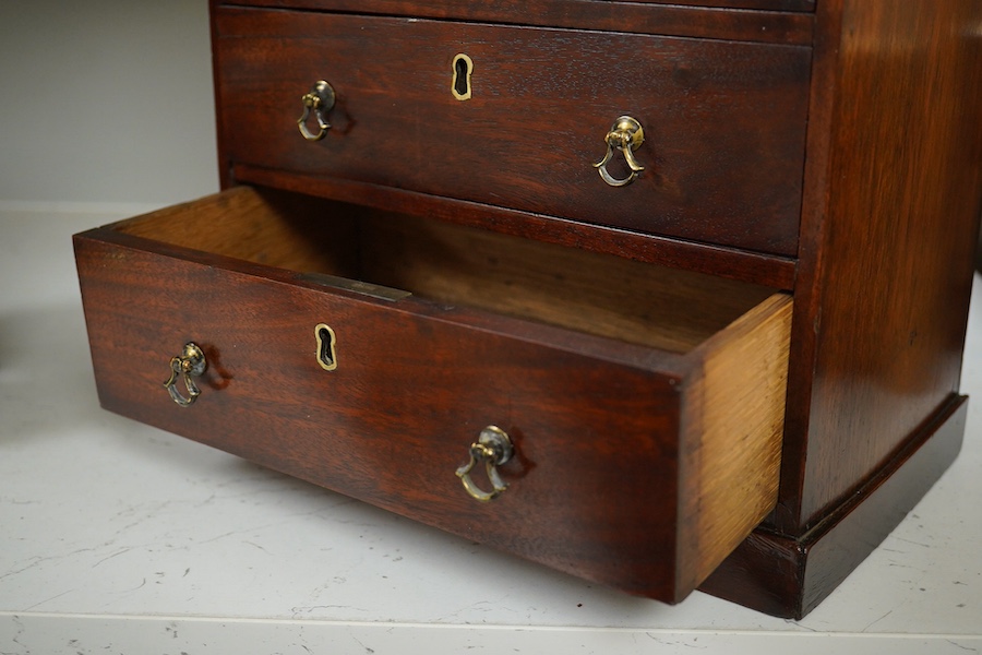 A George III style mahogany miniature chest of five drawers, 30cm high. Condition - fair/good